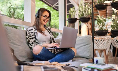 Beautiful student girl learning at home with laptop.